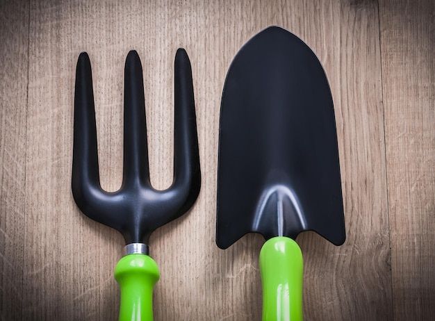 Premium Photo | Gardening Hand Spade With Trowel Fork On Wooden Surface ... within Sustainable Garden Hand Spade