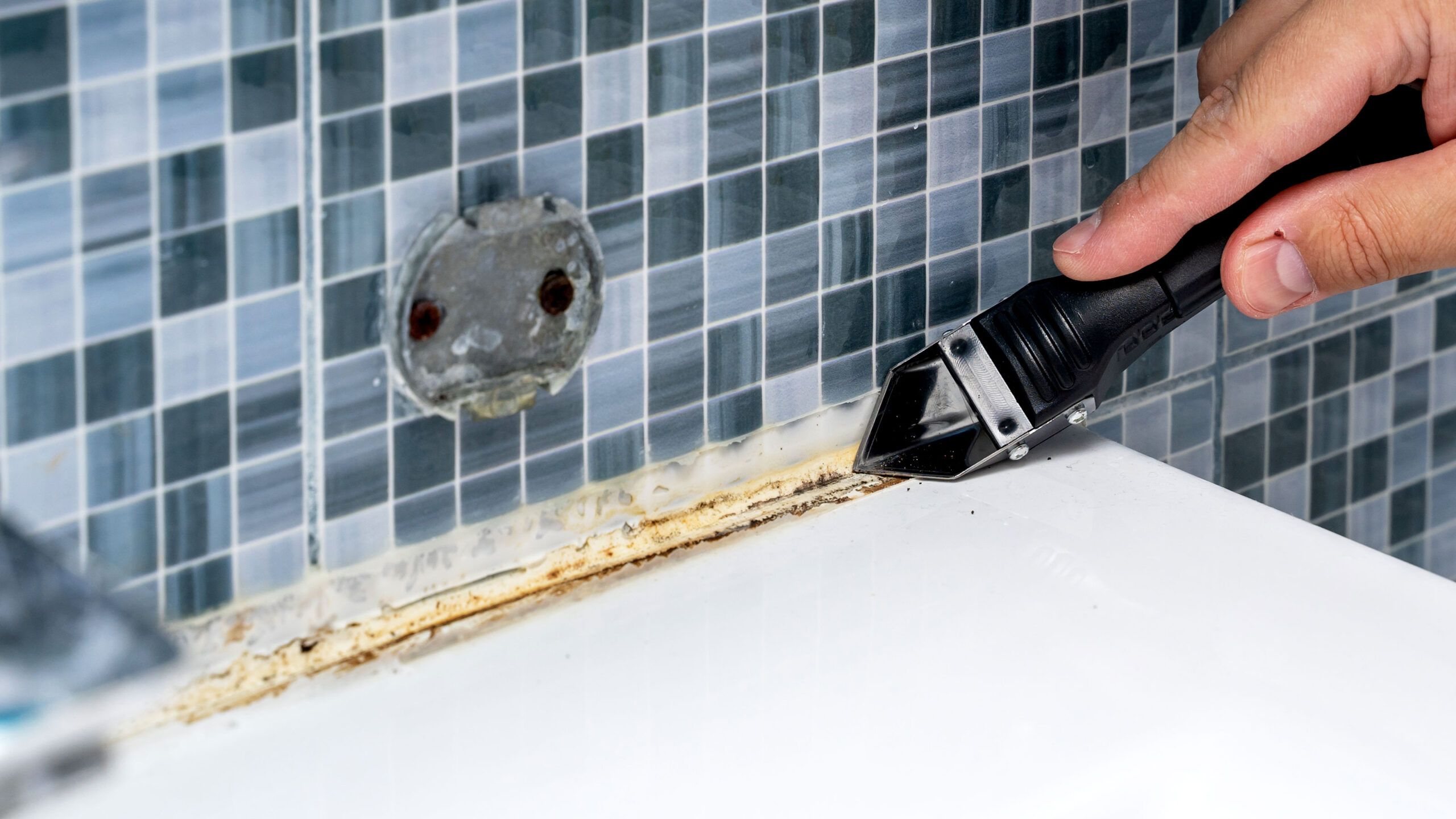 Removing Silicone And Caulk In Three Easy How-To Steps | Homebuilding for Replace Silicone Seal Around Bathtub